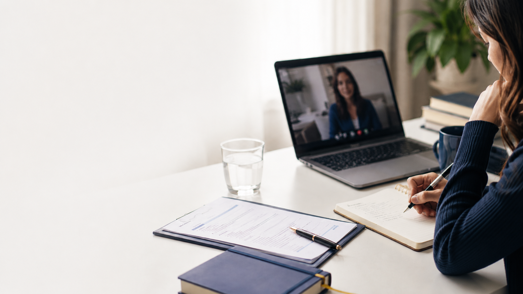 Professional on a remote video call interview at a clean modern desk